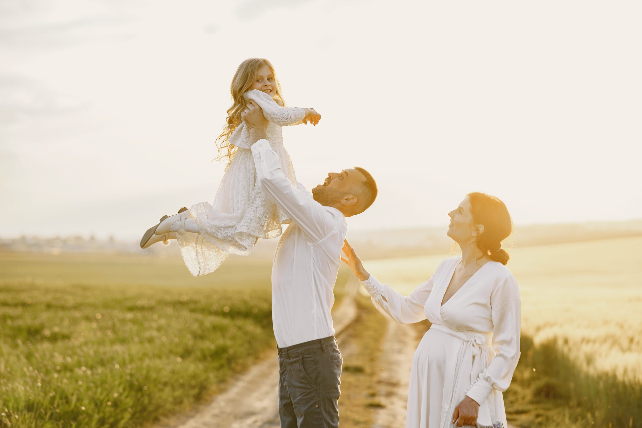 family-with-little-daughter-spending-time-together-sunny-field-min